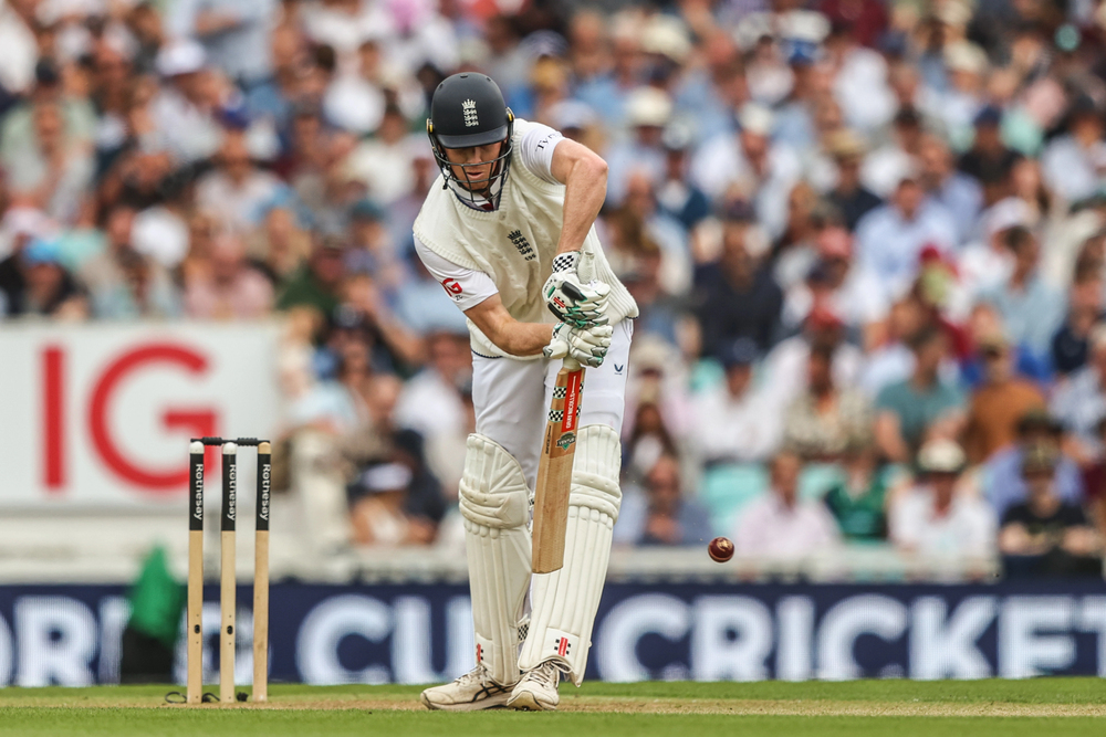 Zak Crawley plays a shot wearing England whites.